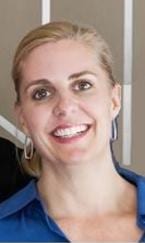 A woman smiling for the camera with her teeth hanging.