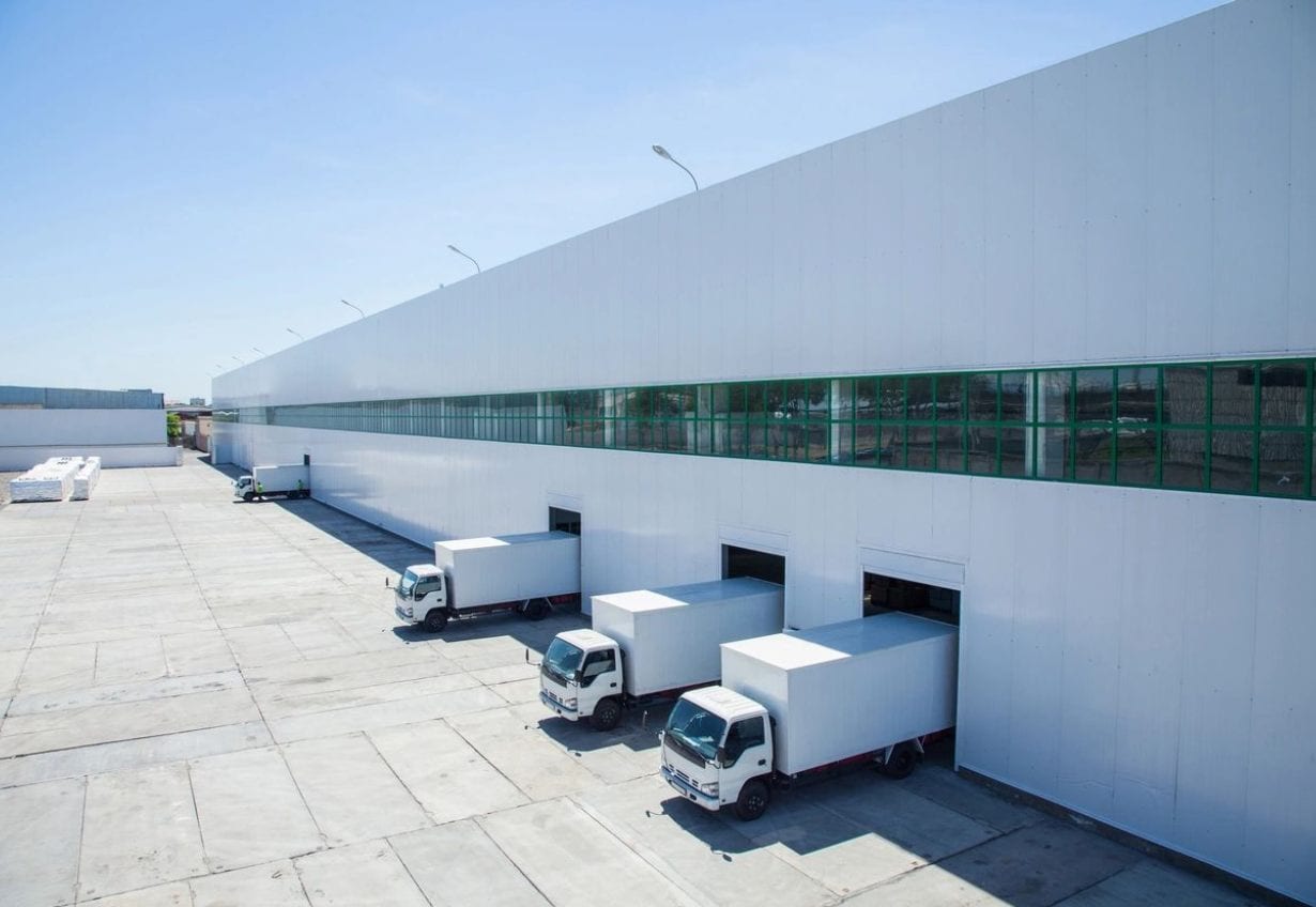 Three trucks parked in front of a building.